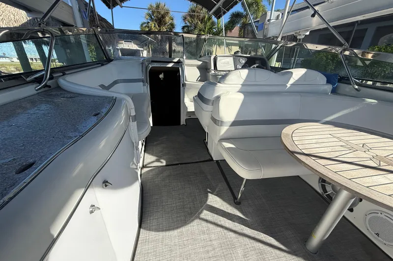 Slide: The Image of 2004 Formula 370 Super Sport boat interior with seating and table, under canopy. - 17