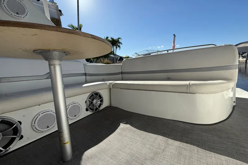 Slide: The Image of 2004 Formula 370 Super Sport boat interior with seating and speakers, under clear blue sky. - 18