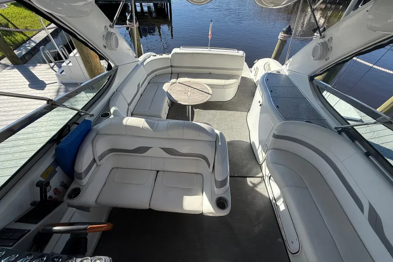 Slide: The Image of Interior of a 2004 Formula 370 Super Sport boat with white seating and table. - 19