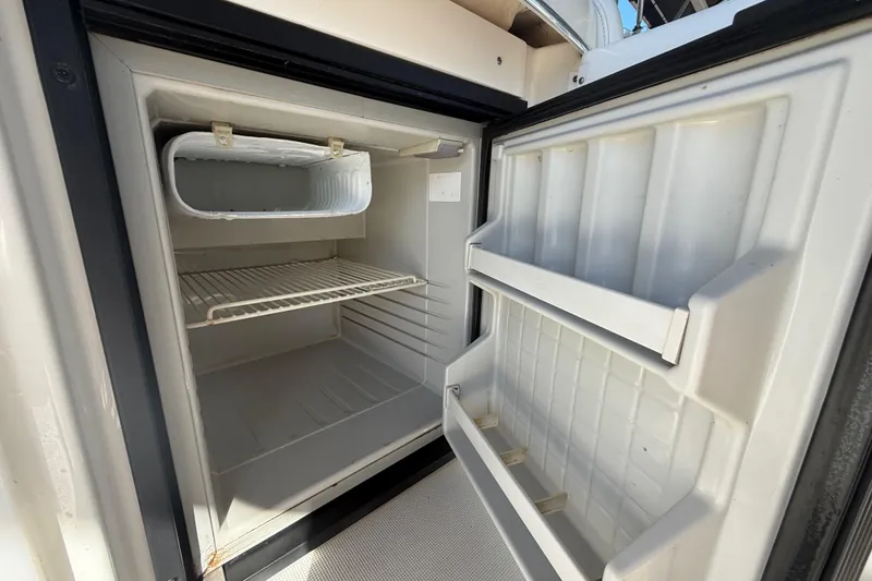 Slide: The Image of Open refrigerator inside a 2004 Formula 370 Super Sport boat. - 23