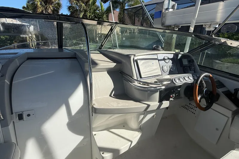 Slide: The Image of 2004 Formula 370 Super Sport boat cockpit with steering wheel and control panel. - 25