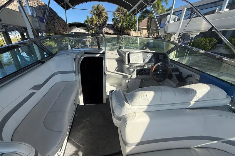 Slide: The Image of 2004 Formula 370 Super Sport boat interior with white seating and modern dashboard. - 26