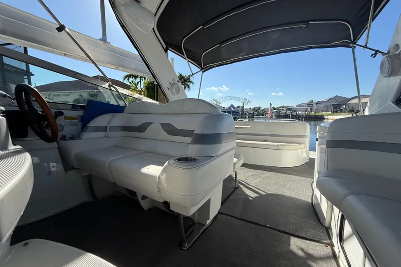 Slide: The Image of 2004 Formula 370 Super Sport boat interior with white seating and canopy. - 27