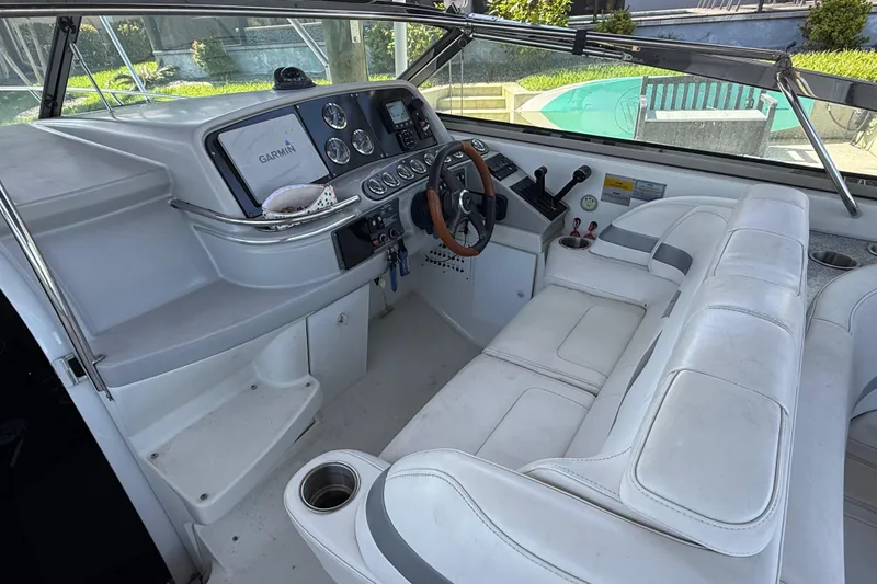 Slide: The Image of Interior of 2004 Formula 370 Super Sport boat with white seating and control panel. - 29