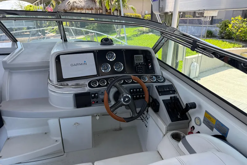 Slide: The Image of 2004 Formula 370 Super Sport boat cockpit with Garmin navigation system and steering wheel. - 30