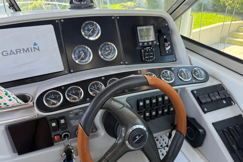 Slide: The Image of 2004 Formula 370 Super Sport dashboard with Garmin navigation and multiple gauges. - 31