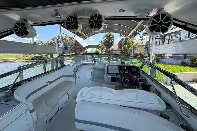 Slide: The Image of 2004 Formula 370 Super Sport boat interior with helm, seating, and speakers. - 34