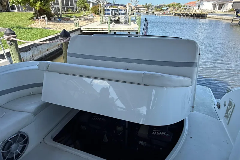 Slide: The Image of 2004 Formula 370 Super Sport boat with open engine compartment by a dock. - 36