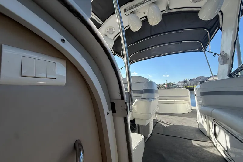 Slide: The Image of 2004 Formula 370 Super Sport boat interior with seating and canopy, dockside view. - 38