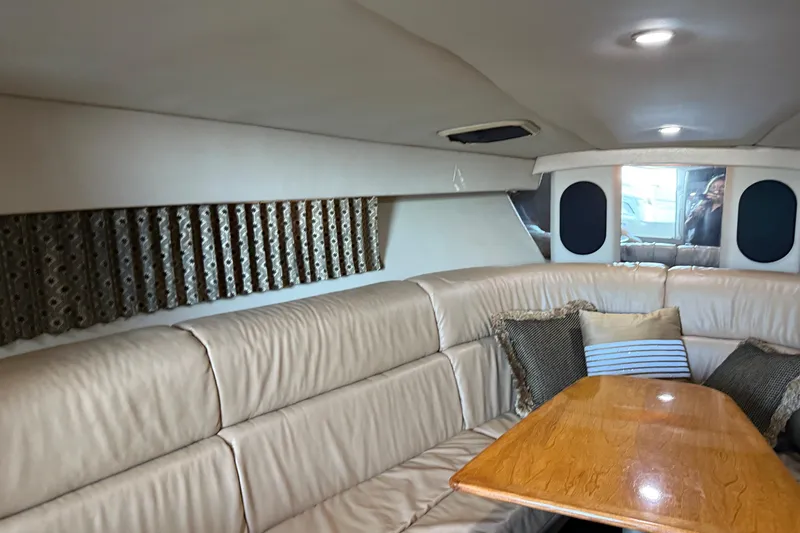 Slide: The Image of Interior of 2004 Formula 370 Super Sport boat with beige seating and wooden table. - 39