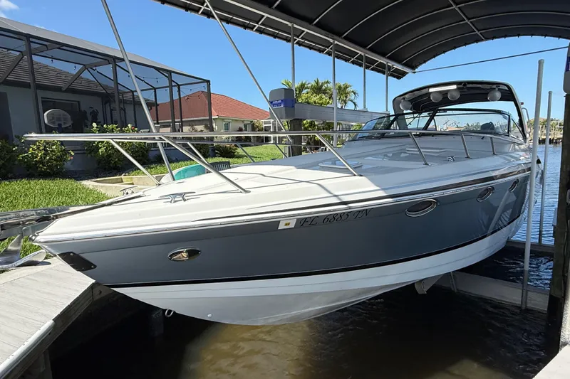 Slide: The Image of 2004 Formula 370 Super Sport boat docked under a canopy on a sunny day. - 4