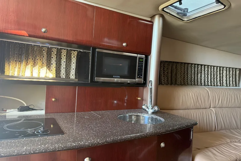 Slide: The Image of Interior of a 2004 Formula 370 Super Sport yacht with kitchenette and seating area. - 41