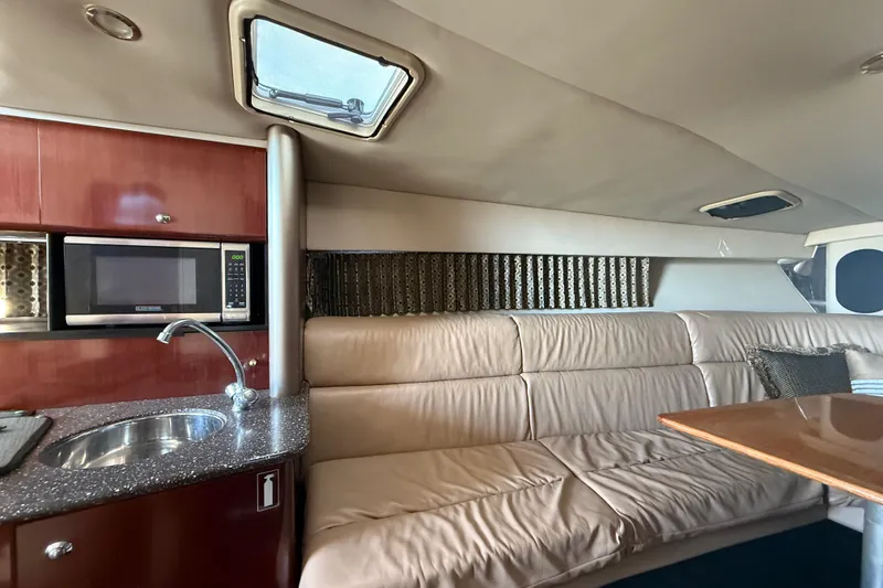 Slide: The Image of Interior of a 2004 Formula 370 Super Sport boat with kitchenette and seating area. - 42