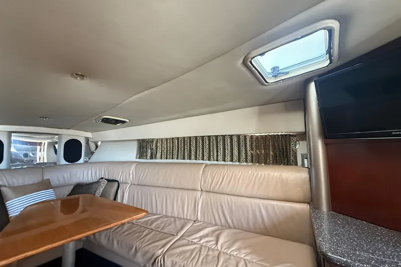 Slide: The Image of Interior of 2004 Formula 370 Super Sport yacht with leather seating and wooden table. - 43