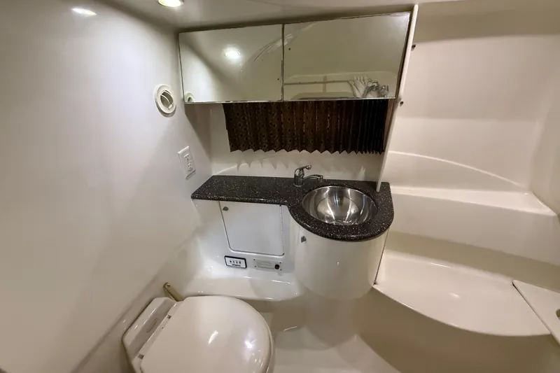 Slide: The Image of 2004 Formula 370 Super Sport boat bathroom with sink, toilet, and mirror. - 45