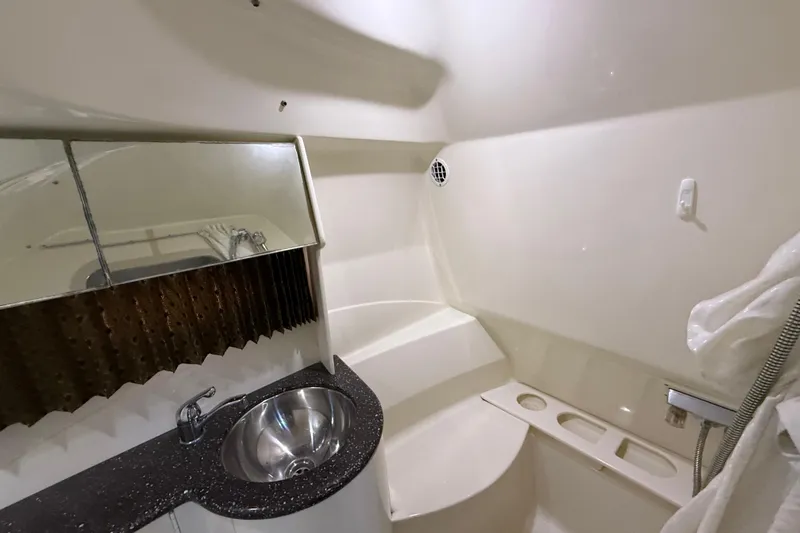 Slide: The Image of 2004 Formula 370 Super Sport boat bathroom with sink and shower area. - 46
