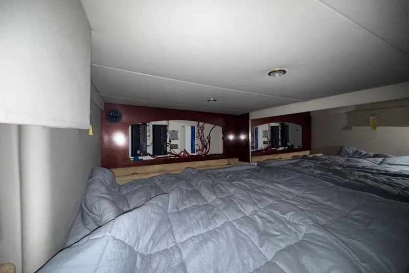 Slide: The Image of Interior cabin of a 2004 Formula 370 Super Sport boat with bedding and control panels. - 49