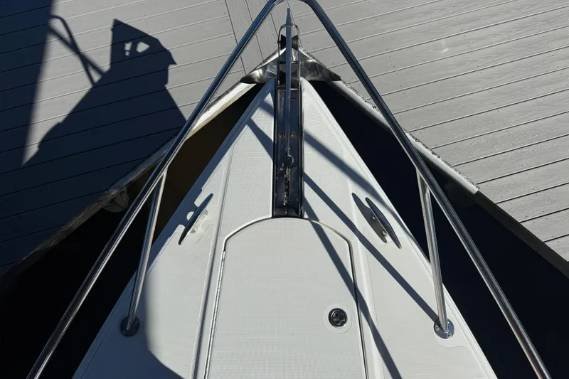 Slide: The Image of Bow of 2004 Formula 370 Super Sport boat docked, showing deck and railings. - 54