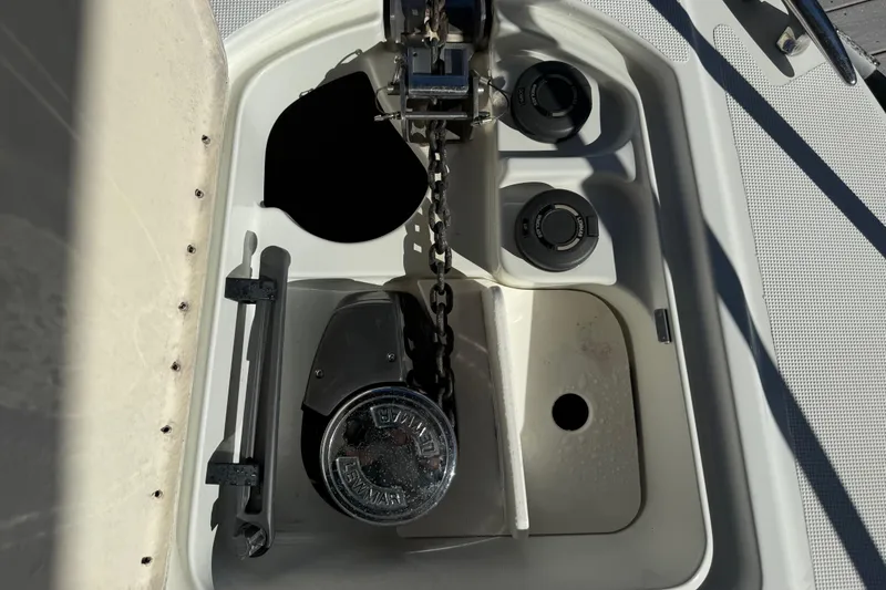 Slide: The Image of Anchor compartment of 2004 Formula 370 Super Sport boat with chain and controls. - 55