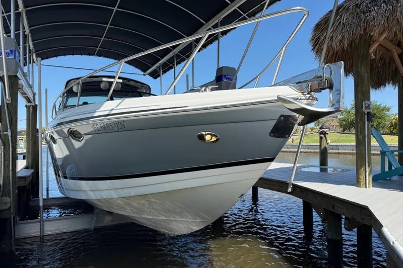 Slide: The Image of 2004 Formula 370 Super Sport boat docked under a canopy on a sunny day. - 6