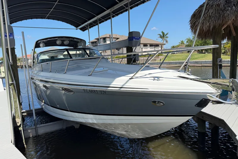 Slide: The Image of 2004 Formula 370 Super Sport boat docked under a canopy in a marina. - 7