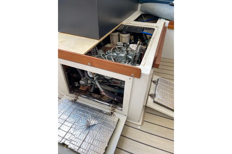 Slide: The Image of 1981 Catalina 30 sailboat engine compartment with open access panels. - 11