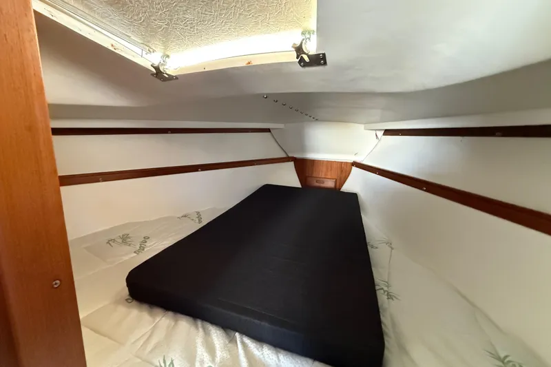 Slide: The Image of Interior cabin of a 1981 Catalina 30 sailboat with a black mattress. - 13