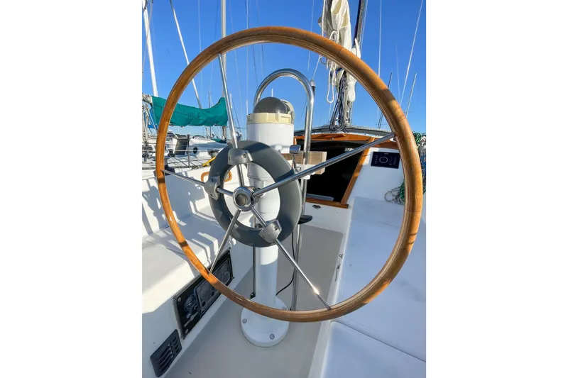 Slide: The Image of 1981 Catalina 30 sailboat helm with wooden wheel and clear blue sky. - 18