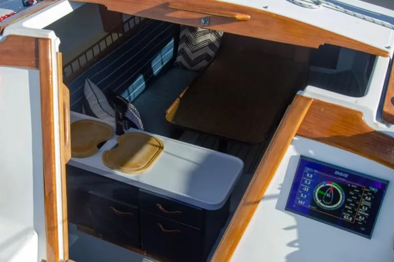 Slide: The Image of Interior view of a 1981 Catalina 30 sailboat with wooden accents and navigation display. - 4