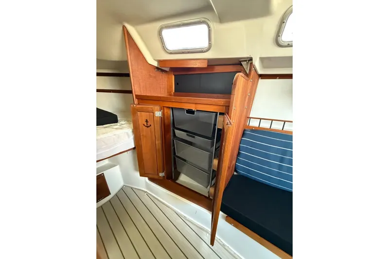 Slide: The Image of Interior of 1981 Catalina 30 sailboat with wooden cabinetry and seating. - 9