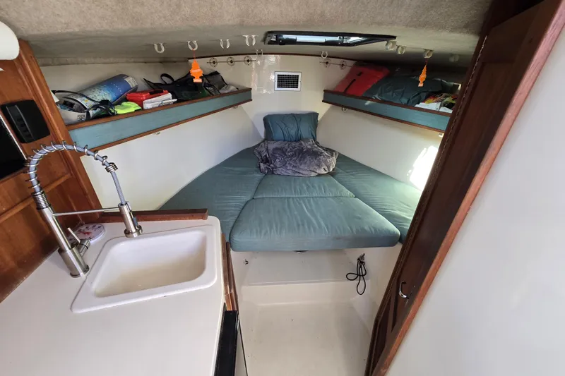 Slide: The Image of Cozy interior of 2002 Carolina Classic 28 Express boat with bed and sink. - 10