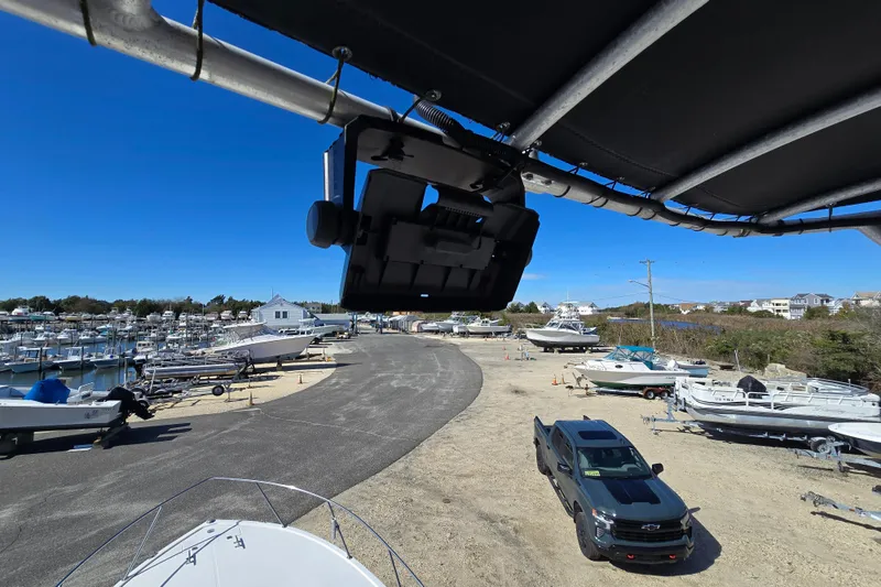 Slide: The Image of Boat yard with 2002 Carolina Classic 28 Express, surrounded by parked boats and a truck. - 16