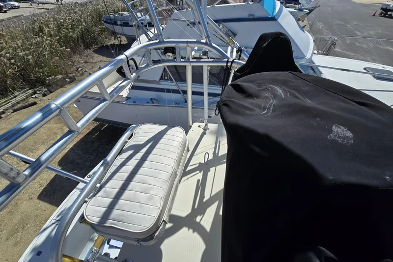Slide: The Image of 2002 Carolina Classic 28 Express boat deck with seating and covered equipment. - 17