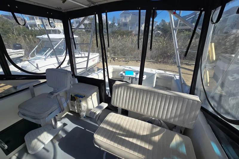 Slide: The Image of Interior of 2002 Carolina Classic 28 Express boat with seating and clear windows. - 6
