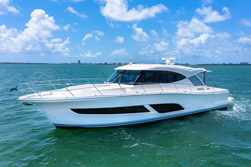 The Image of 2024 Riviera 505 SUV luxury yacht cruising on a sunny day. - 0