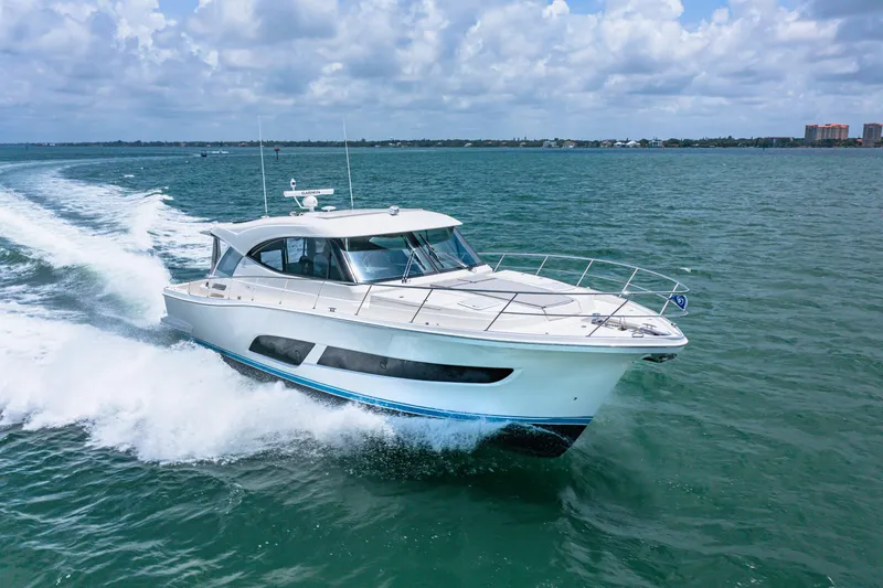 Slide: The Image of 2024 Riviera 505 SUV cruising on open water under a partly cloudy sky. - 11