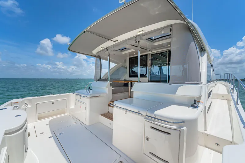 Slide: The Image of 2024 Riviera 505 SUV luxury yacht with spacious deck and ocean view. - 13