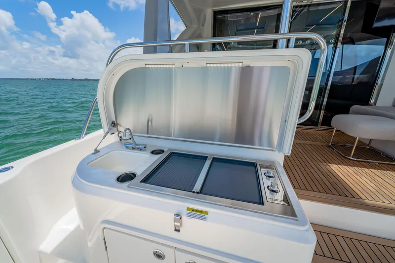 Slide: The Image of 2024 Riviera 505 SUV outdoor kitchen with sink and grill on deck. - 17