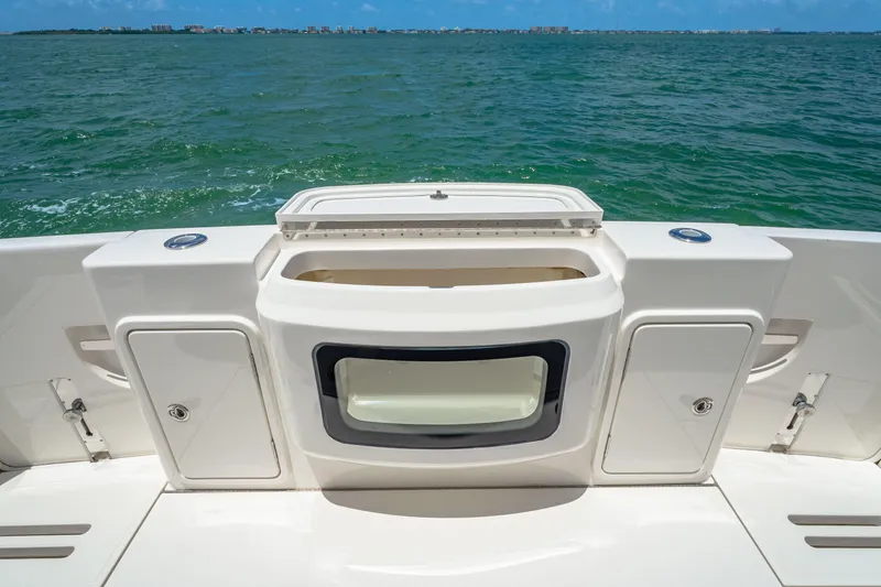 Slide: The Image of 2024 Riviera 505 SUV boat stern with storage compartments and ocean view. - 19