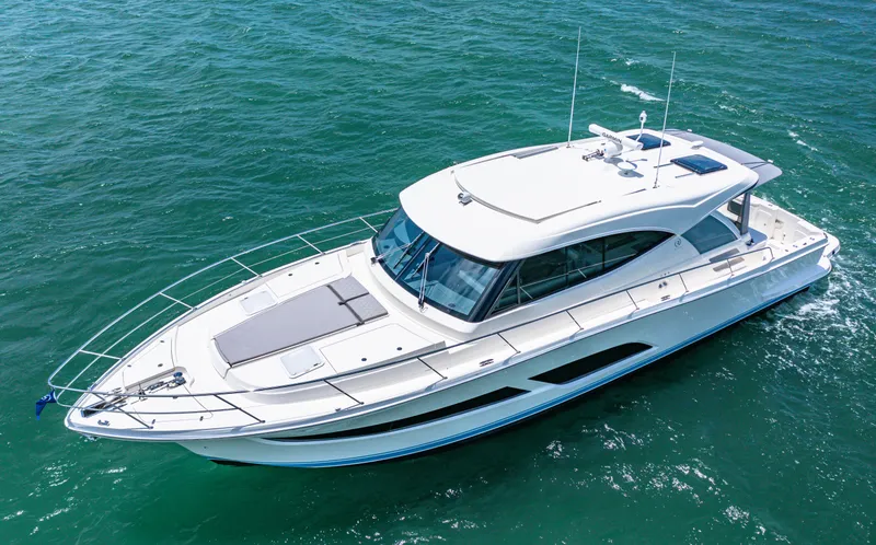 Slide: The Image of 2024 Riviera 505 SUV luxury yacht cruising on open water. - 2