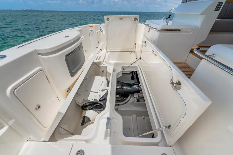 Slide: The Image of 2024 Riviera 505 SUV boat storage compartments open, showcasing spacious interior. - 20