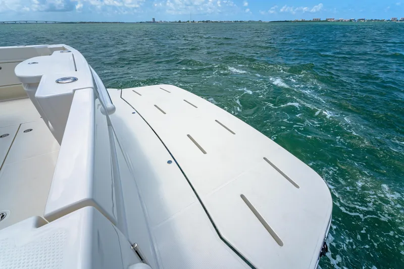 Slide: The Image of 2024 Riviera 505 SUV boat deck on open water. - 21
