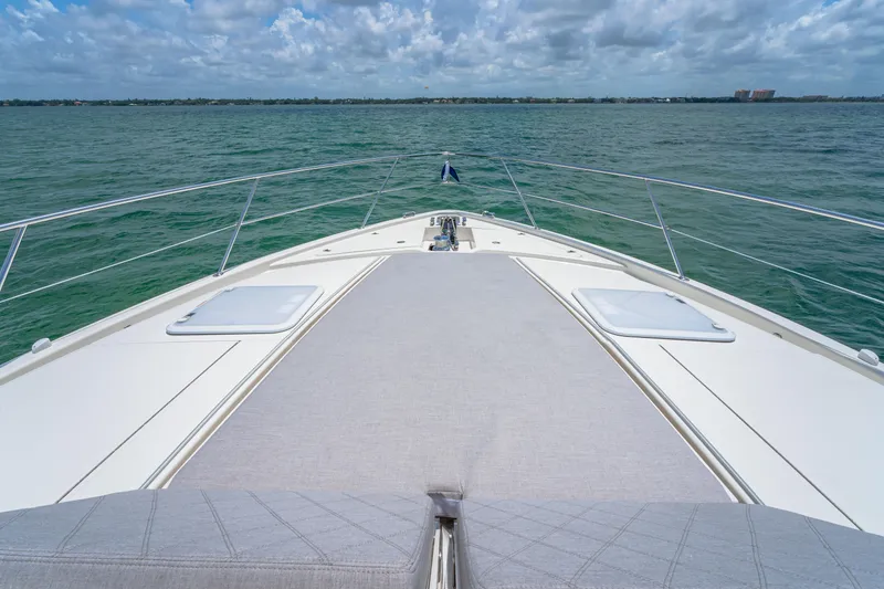 Slide: The Image of Bow view of 2024 Riviera 505 SUV yacht on open water. - 25