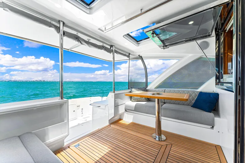 Slide: The Image of 2024 Riviera 505 SUV yacht interior with ocean view and modern seating. - 29