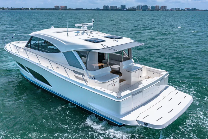 Slide: The Image of 2024 Riviera 505 SUV luxury yacht cruising on open water. - 3