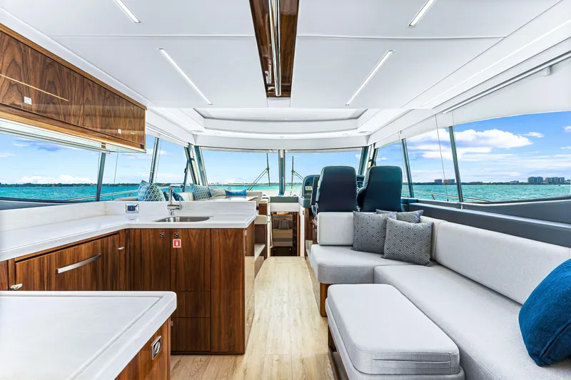 Slide: The Image of Luxurious interior of 2024 Riviera 505 SUV yacht with modern kitchen and seating area. - 33