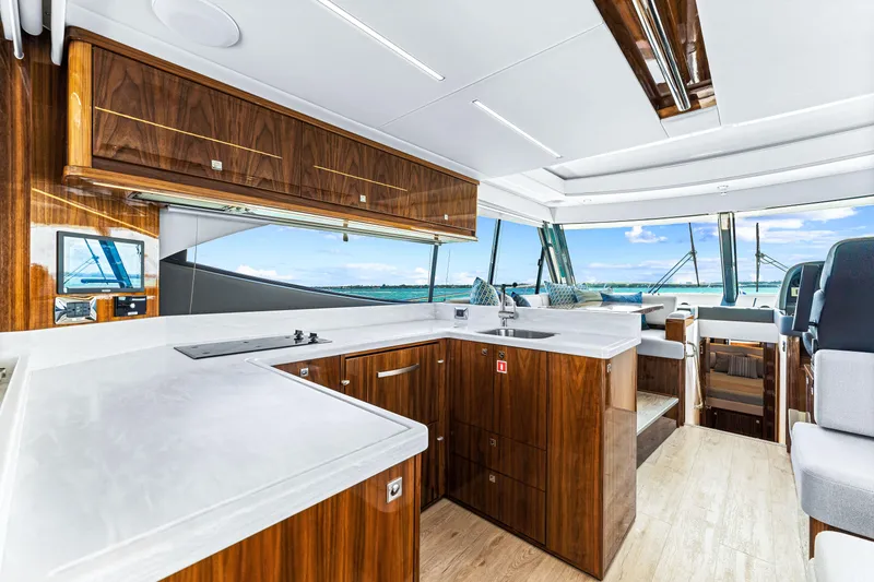 Slide: The Image of Luxurious interior of the 2024 Riviera 505 SUV yacht with modern kitchen and panoramic windows. - 34