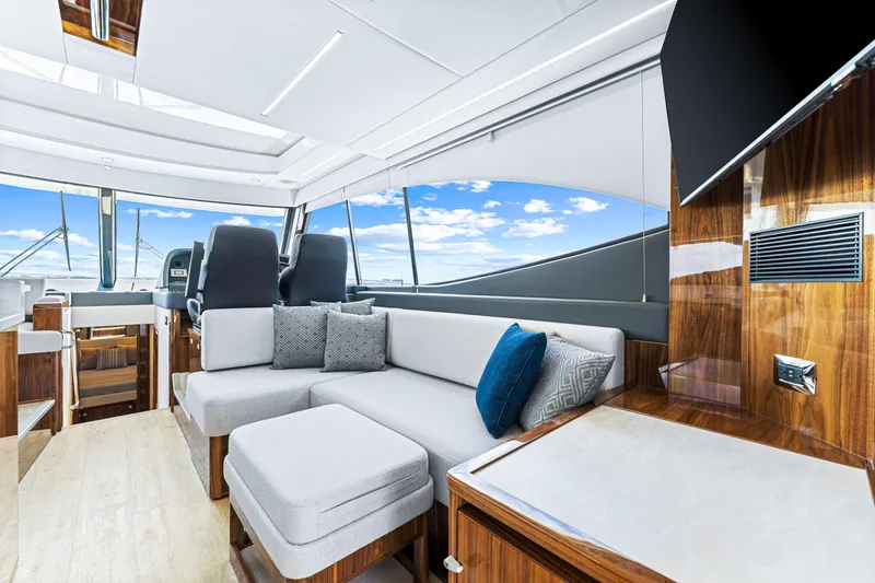 Slide: The Image of Luxurious interior of 2024 Riviera 505 SUV yacht with modern seating and panoramic windows. - 37