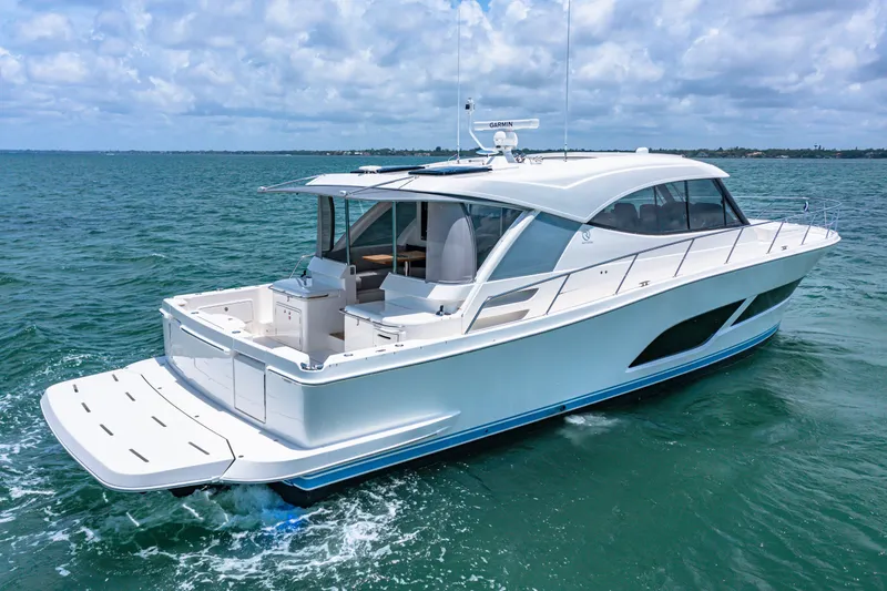 Slide: The Image of 2024 Riviera 505 SUV luxury yacht cruising on open water. - 4