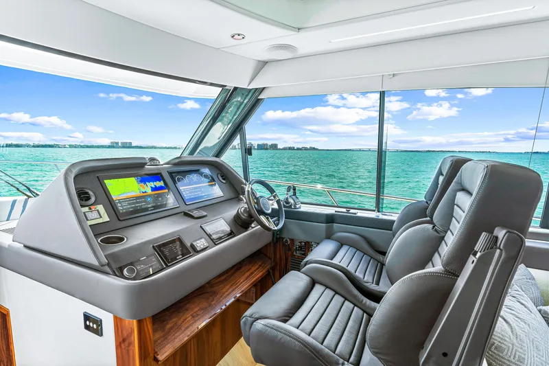 Slide: The Image of 2024 Riviera 505 SUV yacht cockpit with advanced navigation system and luxurious seating. - 41